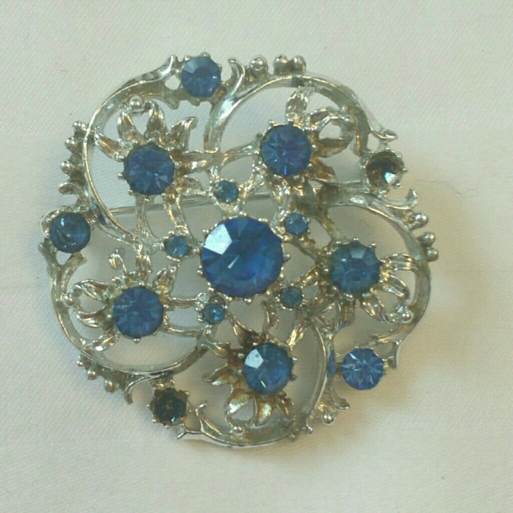Silver tone brooch with blue rhinestones, 2 missing